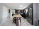Modern kitchen featuring an island with seating, stainless steel appliances, and white tile flooring at 1123 Barley Cir, Carmel, IN 46032