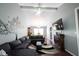 Spacious living room featuring a gray sofa, fireplace, and dining area under vaulted ceiling at 1123 Barley Cir, Carmel, IN 46032