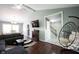 Open living space showcasing a gray sofa, fireplace, and dining table in bright light at 1123 Barley Cir, Carmel, IN 46032
