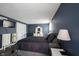 Comfortable main bedroom with a dark blue accent wall and decorative white furniture at 1123 Barley Cir, Carmel, IN 46032