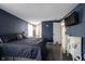A main bedroom with a dark blue wall, decorative chests and wood look floors at 1123 Barley Cir, Carmel, IN 46032