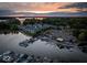 Aerial view of Bridgewater community clubhouse, marina, and waterfront homes at sunset at 12304 Ridgeside Rd, Indianapolis, IN 46256