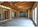 Unfinished basement with exposed wood beams, concrete floor, and studded walls, offering potential for customization at 12304 Ridgeside Rd, Indianapolis, IN 46256