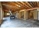 Spacious unfinished basement with exposed framing and ductwork, offering potential for customization and expansion at 12304 Ridgeside Rd, Indianapolis, IN 46256