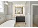 Bathroom featuring a vanity with granite countertop and decorative backsplash, along with a soaking tub at 12304 Ridgeside Rd, Indianapolis, IN 46256