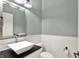 Stylish powder room featuring modern fixtures, white subway tile, and a vessel sink at 12304 Ridgeside Rd, Indianapolis, IN 46256