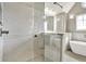 Bathroom featuring an enclosed glass shower and soaking tub combo, with modern tile and finishes at 12304 Ridgeside Rd, Indianapolis, IN 46256