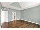 Large bedroom with beautiful hardwood floors, a vaulted ceiling, and a view into the bathroom at 12304 Ridgeside Rd, Indianapolis, IN 46256