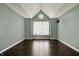 Spacious bedroom features high ceilings, a large window, and gleaming hardwood floors at 12304 Ridgeside Rd, Indianapolis, IN 46256