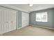 Neutral bedroom featuring carpet floors, a large window, and ample closet space at 12304 Ridgeside Rd, Indianapolis, IN 46256