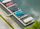 Aerial view of a private boat slip with multiple covered boat lifts on a calm lake at 12304 Ridgeside Rd, Indianapolis, IN 46256