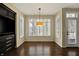 Bright dining room features built-in cabinets, hardwood flooring, a door, and large windows at 12304 Ridgeside Rd, Indianapolis, IN 46256