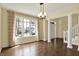 Bright dining room features hardwood floors, large windows, and elegant chandelier at 12304 Ridgeside Rd, Indianapolis, IN 46256