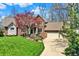 Exterior of a two-story brick home with lush green lawn, mature trees, and a two car garage at 12304 Ridgeside Rd, Indianapolis, IN 46256