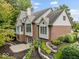 Exterior of a two-story brick home with manicured landscaping and mature trees at 12304 Ridgeside Rd, Indianapolis, IN 46256