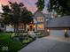 Beautiful brick home with manicured landscaping and a spacious driveway leading to a three-car garage at 12304 Ridgeside Rd, Indianapolis, IN 46256