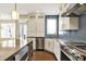 Modern kitchen featuring a center island, stainless steel appliances, white cabinets, and hardwood flooring at 12304 Ridgeside Rd, Indianapolis, IN 46256
