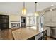 Open concept kitchen with island, seamlessly flowing into the living area with a cozy fireplace at 12304 Ridgeside Rd, Indianapolis, IN 46256