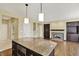 The kitchen island provides seating and prep space, and is adjacent to the living area with fireplace at 12304 Ridgeside Rd, Indianapolis, IN 46256