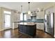 Bright kitchen with white cabinets, stainless steel appliances, a center island, and hardwood flooring at 12304 Ridgeside Rd, Indianapolis, IN 46256