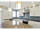 Bright kitchen featuring sleek white cabinets, stainless steel appliances, and a blue tile backsplash at 12304 Ridgeside Rd, Indianapolis, IN 46256