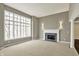 Spacious living room with fireplace, large windows, and neutral carpet at 12304 Ridgeside Rd, Indianapolis, IN 46256