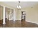 Bright, open-concept living room featuring hardwood floors, grand columns, and staircase at 12304 Ridgeside Rd, Indianapolis, IN 46256