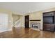 Open living room with a staircase in view, a fireplace, built-in cabinets, and hardwood flooring throughout at 12304 Ridgeside Rd, Indianapolis, IN 46256