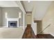 Hallway with beautiful columns, hardwood floors, fireplace, and staircase at 12304 Ridgeside Rd, Indianapolis, IN 46256