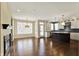 Open concept living room and kitchen with hardwood floors, a fireplace, and large bright windows at 12304 Ridgeside Rd, Indianapolis, IN 46256
