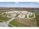 Aerial view showcasing a large school building with sports fields, parking and landscaped grounds at 12536 Lowery Way, Fishers, IN 46037