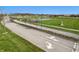 High-angle shot shows a pathway lined with trees, leading to expansive sports fields and a school complex at 12536 Lowery Way, Fishers, IN 46037