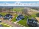 Expansive aerial view of a light-colored home with green lawn nestled within a developing residential community at 12536 Lowery Way, Fishers, IN 46037