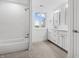Bright bathroom with modern vanity, walk in shower, and a large window with outside views at 12536 Lowery Way, Fishers, IN 46037