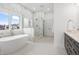 Bright bathroom featuring a freestanding tub, walk-in shower, and marble countertops at 12536 Lowery Way, Fishers, IN 46037