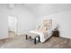Well-lit bedroom with neutral colors, carpet, and a comfortable bed with bench at 12536 Lowery Way, Fishers, IN 46037