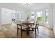 Bright dining room area featuring hardwood floors, bright windows and stylish light fixture at 12536 Lowery Way, Fishers, IN 46037