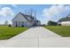 Traditional home featuring a long driveway, ample parking, three car garage and manicured lawn at 12536 Lowery Way, Fishers, IN 46037