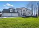 Stunning two-story home featuring a three-car garage and a well-manicured lawn at 12536 Lowery Way, Fishers, IN 46037
