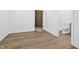 Hallway with hardwood floors leading to the bathroom, and view of another room at 12536 Lowery Way, Fishers, IN 46037