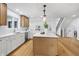 Open concept kitchen with an island, sleek appliances, white cabinets, and views of the staircase and dining area at 12536 Lowery Way, Fishers, IN 46037