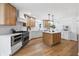 Bright kitchen with stainless steel appliances, an island with pendant lights, and white countertops and cabinets at 12536 Lowery Way, Fishers, IN 46037