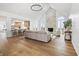 Bright living room with stone fireplace, hardwood floors, and a view into the kitchen at 12536 Lowery Way, Fishers, IN 46037