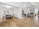 Open floor plan featuring hardwood floors, stone fireplace and a dining room with chandelier at 12536 Lowery Way, Fishers, IN 46037