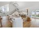 Bright, open-concept living room with a modern chandelier and hardwood floors at 12536 Lowery Way, Fishers, IN 46037