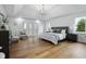 Beautiful main bedroom features hardwood floors, a tray ceiling, and a chandelier at 12536 Lowery Way, Fishers, IN 46037