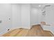 Bright mud room features a built-in bench with coat hooks and beautiful hardwood floors at 12536 Lowery Way, Fishers, IN 46037