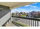Spacious balcony with black wooden railing and a view of the community at 12588 Tennyson Ln # 205, Carmel, IN 46032