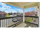 Spacious balcony with black wooden railing and a view of the parking lot at 12588 Tennyson Ln # 205, Carmel, IN 46032