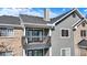 A balcony view showcasing the gray railing, siding, and white trim of the condominium building at 12588 Tennyson Ln # 205, Carmel, IN 46032